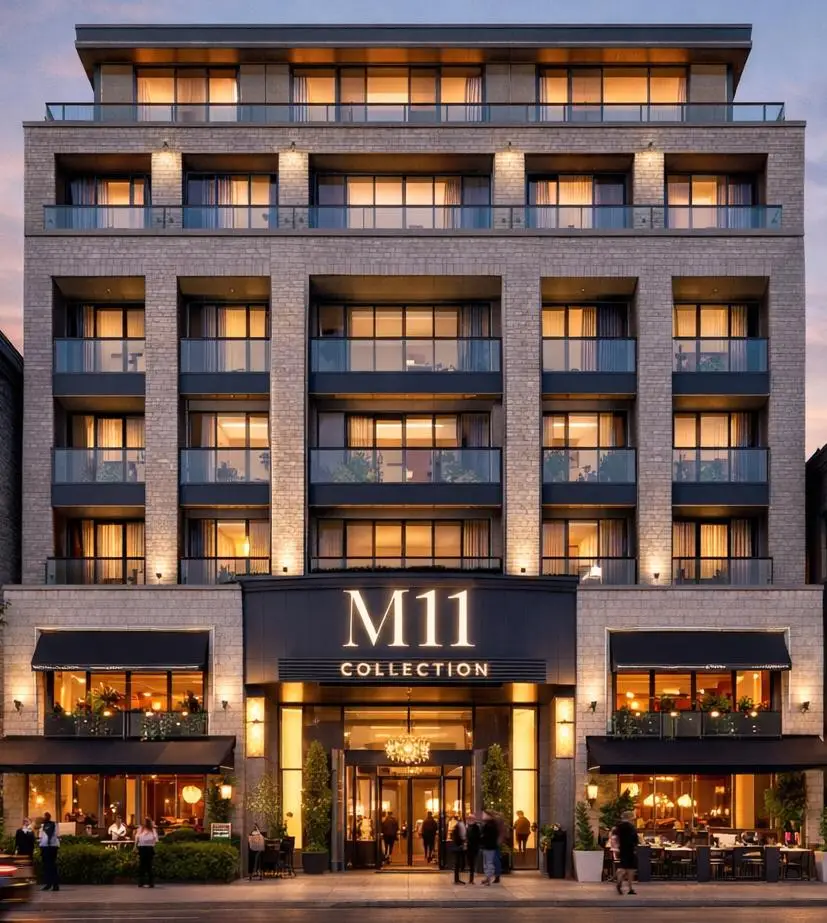 Mahbod Group A modern, multi-storey hotel building with balconies and large windows showcases the "M11 Collection," a hospitality brand under a Private Holding Company. People gather at the entrance and outdoor dining area, creating a vibrant atmosphere.